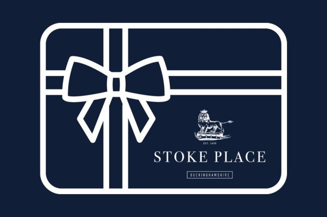 A navy gift box illustration with a white ribbon and bow, featuring the Stoke Place logo and Buckinghamshire text.