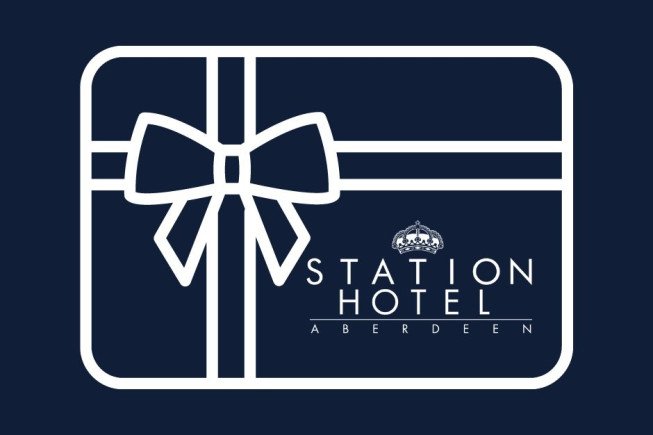 A white outline of a wrapped gift box with a bow on a dark blue background, with the words "Station Hotel Aberdeen" on the lower right.
