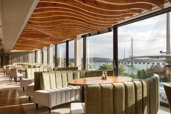 Interior of a modern restaurant featuring large windows and river view