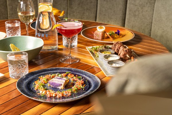 A beautifully arranged table with various gourmet dishes and drinks.