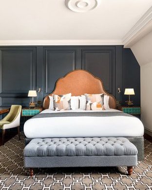 A modern hotel room featuring a large bed and elegant decor.