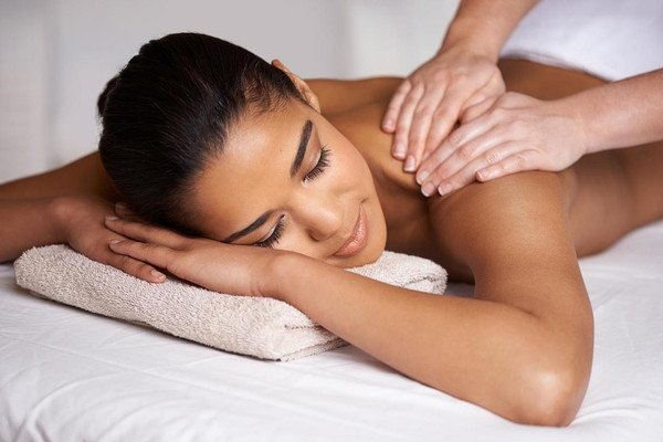 A woman receiving a relaxing massage on her back