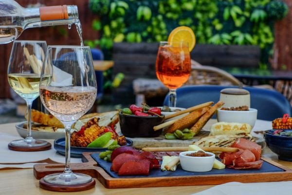 A beautifully arranged charcuterie board with wine glasses