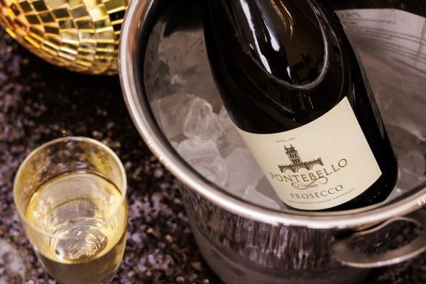 A bottle of Montebello Prosecco in an ice bucket with a glass nearby